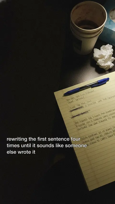 A legal pad under a desk light: "rewriting the first sentence four times until it sounds like someone else wrote it".